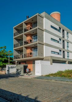 an apartment building with balconies on the second floor