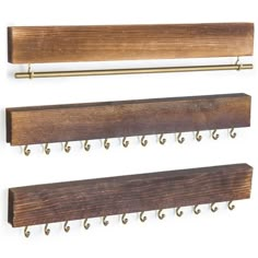 three wooden coat racks with hooks on them