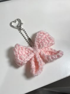 a crocheted key chain with a pink bow on it