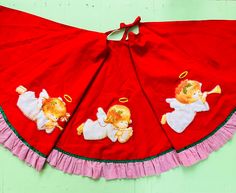 a red dress with two teddy bears on it