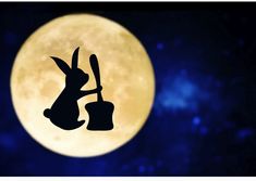 the silhouette of a rabbit holding a bucket and shovel in front of a full moon