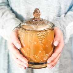 a person holding a glass jar in their hands