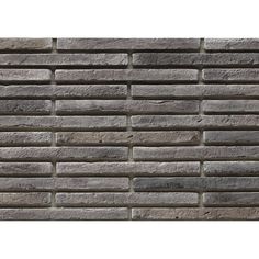 a brick wall made out of grey bricks