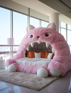 a large pink monster bed in the middle of a room