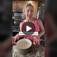 a woman standing in front of a counter with a bowl on it