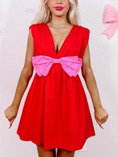 Bow Me Away Red Dress | Sassy Shortcake | sassyshortcake.com Playful Pink V-neck Dress, Red Sleeveless Dress With Bow, Red Summer Dress With Bow, Flirty Pink Mini Dress With Bow, Summer V-neck Mini Dress With Bow, Playful Pink Dress With Bow, Cute V-neck Mini Dress For Party, Flirty Pink Dress With Bow, Summer Party Dress With Red Bow