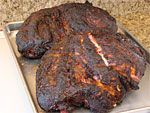 two large steaks sitting on top of a metal pan