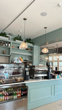 the inside of a restaurant with lots of food and drinks on display at the counter