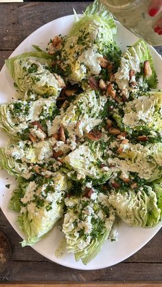 a white plate topped with lettuce covered in cheese