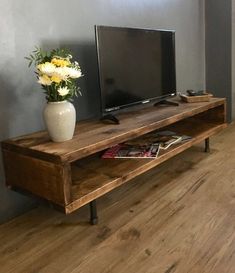 a wooden entertainment center with a flat screen tv sitting on it's side shelf