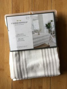 two folded towels sitting next to each other on top of a wooden floor