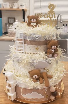 a three tiered cake decorated with teddy bears