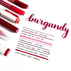 some red and white markers are on top of a paper with the word burgundy written in it