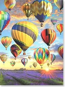 many hot air balloons flying in the sky above lavender fields at sunset with sun rays