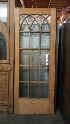 a wooden door with glass on the front and side doors to both sides in a warehouse