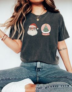 Get into the holiday spirit with this Retro Santa T-Shirt featuring a vintage Santa Claus design along with Christmas tree accents. Perfect for those who love a touch of retro charm during the holiday season, this unisex garment-dyed T-shirt is made for ultimate comfort and style. Ideal for Christmas celebrations and festive gatherings, this tee comes in a range of sizes to suit everyone. Product features - Available in multiple sizes from S to 4XL - Double-needle stitching for durability - Without side seams for a seamless look - Garment-dyed fabric for soft texture - Made with 100% ring-spun US cotton for comfort Care instructions - Machine wash: cold (max 30C or 90F) - Do not bleach - Tumble dry: low heat - Iron, steam or dry: low heat - Do not dryclean Funny Santa Shirts, Retro Christmas Shirt, Retro Santa, Santa Shirt, Christmas Tree Shirt, Funny Santa, Santa Shirts, Vintage Santa Claus, Xmas Shirts