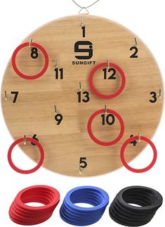 a wooden clock with red, blue and black rings