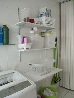 a washer and dryer sitting next to each other in a room with white walls