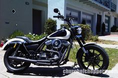 a black and white motorcycle parked in front of a building