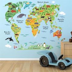 a child's room with a blue wall and a large world map on the wall