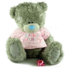 a green teddy bear wearing a pink shirt with the words happy birthday written on it