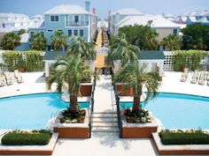 an aerial view of a pool with palm trees