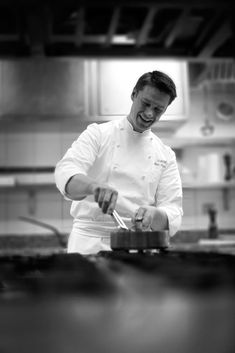 a man in a chef's outfit is preparing food