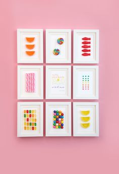 six framed art pieces on a pink wall with candy candies and lollipops