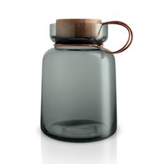 a glass jar with a wooden lid and handle on the top is shown in front of a white background