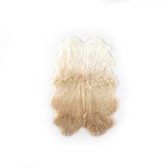 a sheepskin rug on a white background with no one in the photo looking at it