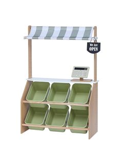 a wooden shelf with six green dishes and a sign that says we are off - ex