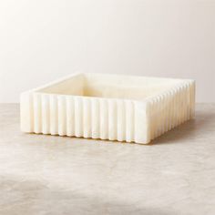 a large white toothbrush holder sitting on top of a table