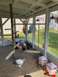 a chicken coop with chickens in it and on the ground next to an open door