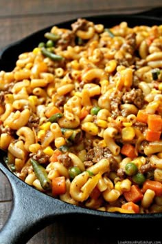 a skillet filled with pasta and vegetables