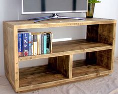 a wooden entertainment center with bookshelves and a flat screen tv