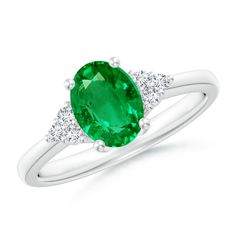 An oval emerald prong set on the platinum band, evokes a lush green allure. It is flanked by trios of sparkling diamonds that enhance the fascinating emerald. The reverse tapered shank of this solitaire emerald ring infuses a sophisticated edge to the design. Emerald Solitaire Ring, Smaragd Ring, Emerald Rings, Ring Settings, Rose Gold Band, May Birthstone, White Gold Band, American Diamond, Emerald Gemstone