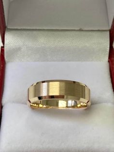 a gold wedding band in a box