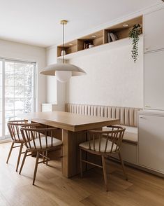 a dining room table with four chairs around it