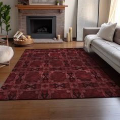 a living room filled with furniture and a red rug on top of a hard wood floor