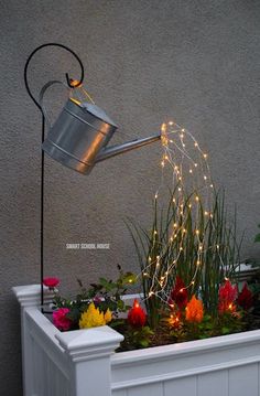 a potted planter filled with flowers and lights