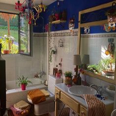 a bathroom with a sink, toilet and bathtub next to a window in it