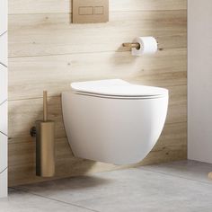 a white toilet sitting next to a wooden wall