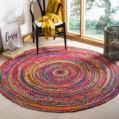 a colorful rug in the corner of a room with a chair and window behind it