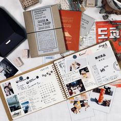 an open planner book sitting on top of a table next to other items and papers