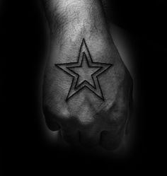 a hand with a star tattoo on it