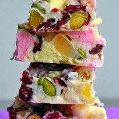 a stack of different types of food on top of each other in front of a purple background