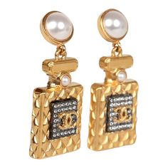 These Chanel Crystal Pearl Perfume Bottle dangle earrings are in gold tone hardware, featuring a gold tone quilted Chanel perfume bottle with faux crystals and the signature CC logo on the front dangling from a small pearl stud earring with post back earring closures.Origin: FranceCondition: New and never wornAccompanied by: Chanel jewelry boxMeasurements: .6" x 1.5" Chanel Pearl Earrings, Chanel Perfume Bottle, Dangle Earrings Gold, Chanel Pearls, Chanel Perfume, Idea Design, Chanel Earrings, Chanel Jewelry, Gold Earrings Dangle