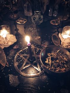 a table topped with candles and dishes filled with food