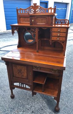 an antique wooden desk with drawers and mirror