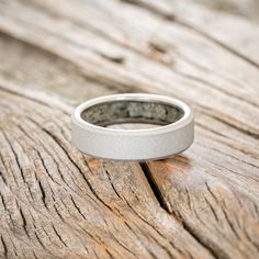 a wedding ring sitting on top of a wooden table